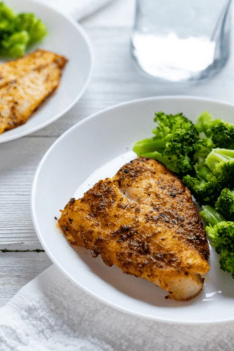 crispy air fryer chilean sea bass topped with lemon garlic butter close up