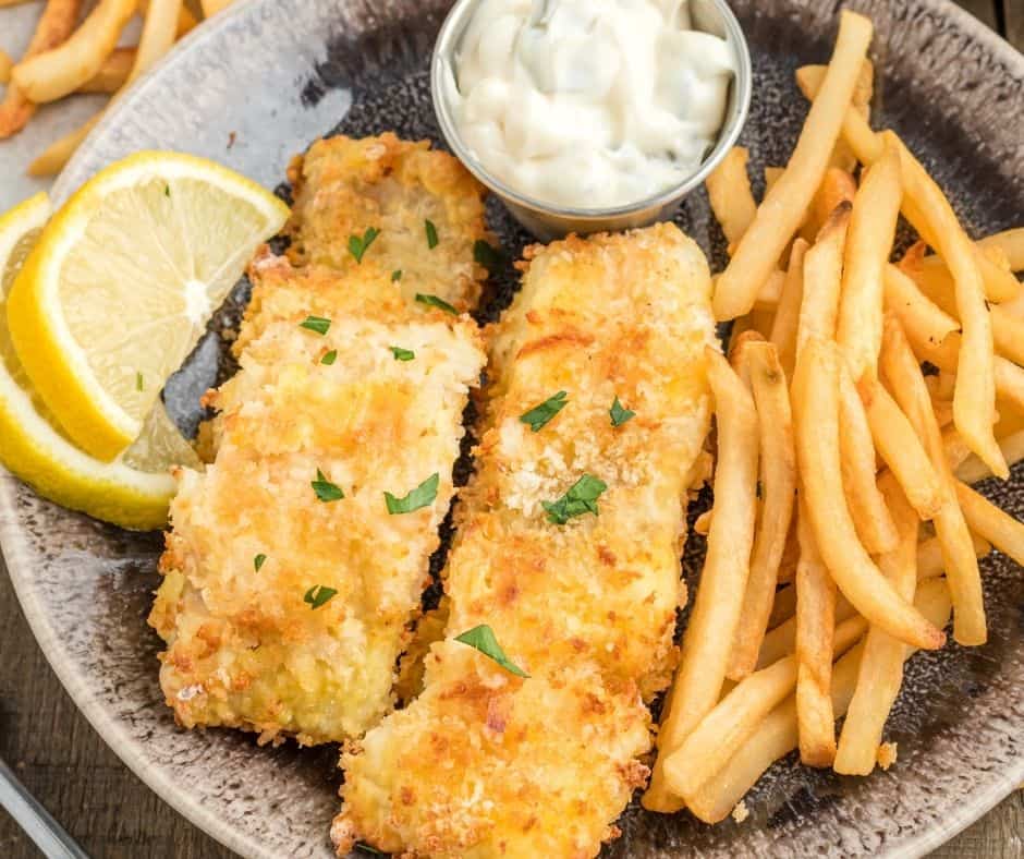 Golden-brown and crispy Air Fryer Panko Cod fillet on a plate with garnish.
