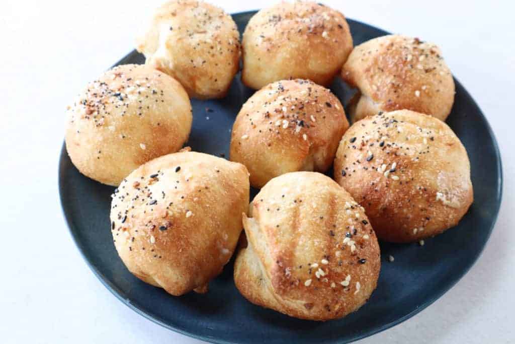 Finished Stuffed Bagel Balls: A plate of golden, crispy stuffed bagel balls, ready to be served.