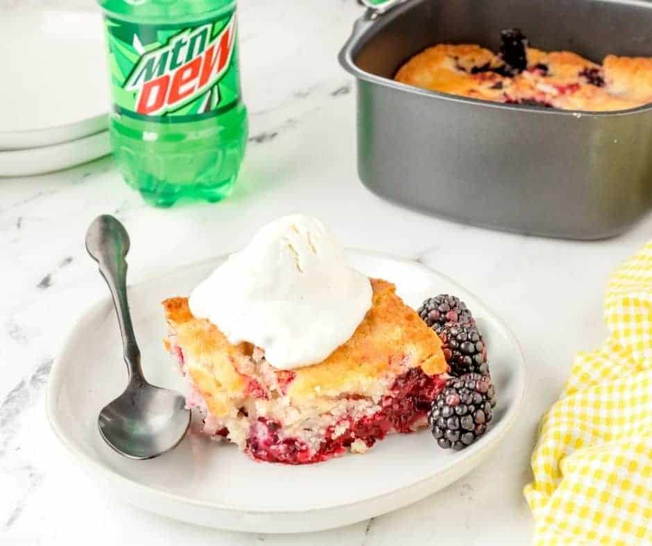 Plate of blackberry cobbler with a scoop of vanilla ice cream.