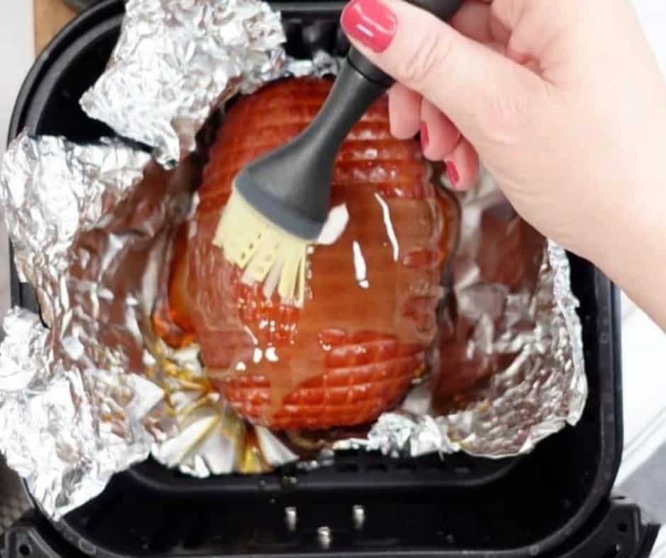 Ham placed in a foil package, topped with honey glaze, ready to be air fried for 20 minutes.