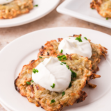 Golden, shatteringly crispy potato latkes with a fluffy center — no pot of splattering oil required. The moisture secret makes all the difference.