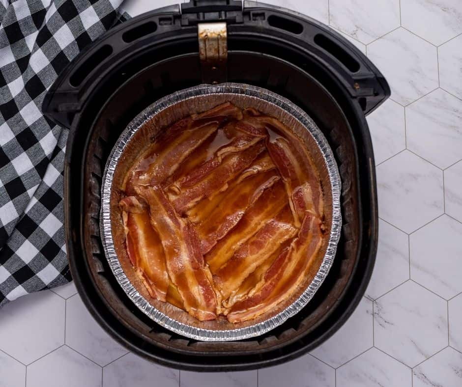 Cooking bacon in the air fryer basket.
