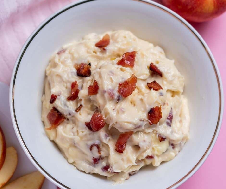 Creamy, bubbly hot dip topped with chunks of candied bacon and a drizzle of maple syrup.
