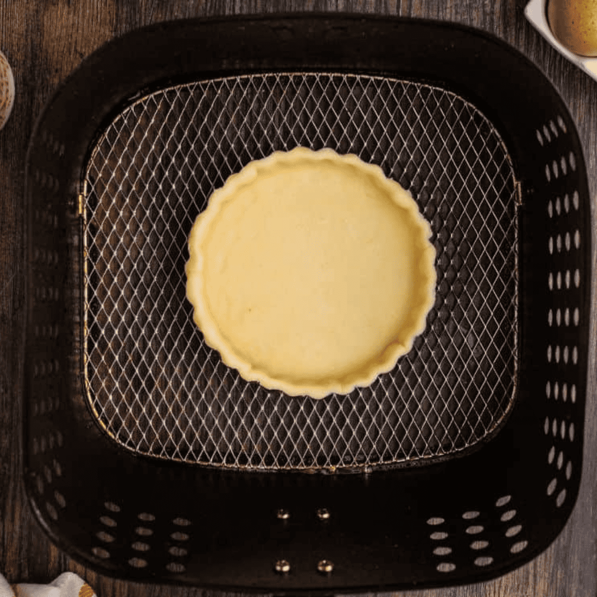 Flaky, golden pie crust made in the air fryer, ready for filling.