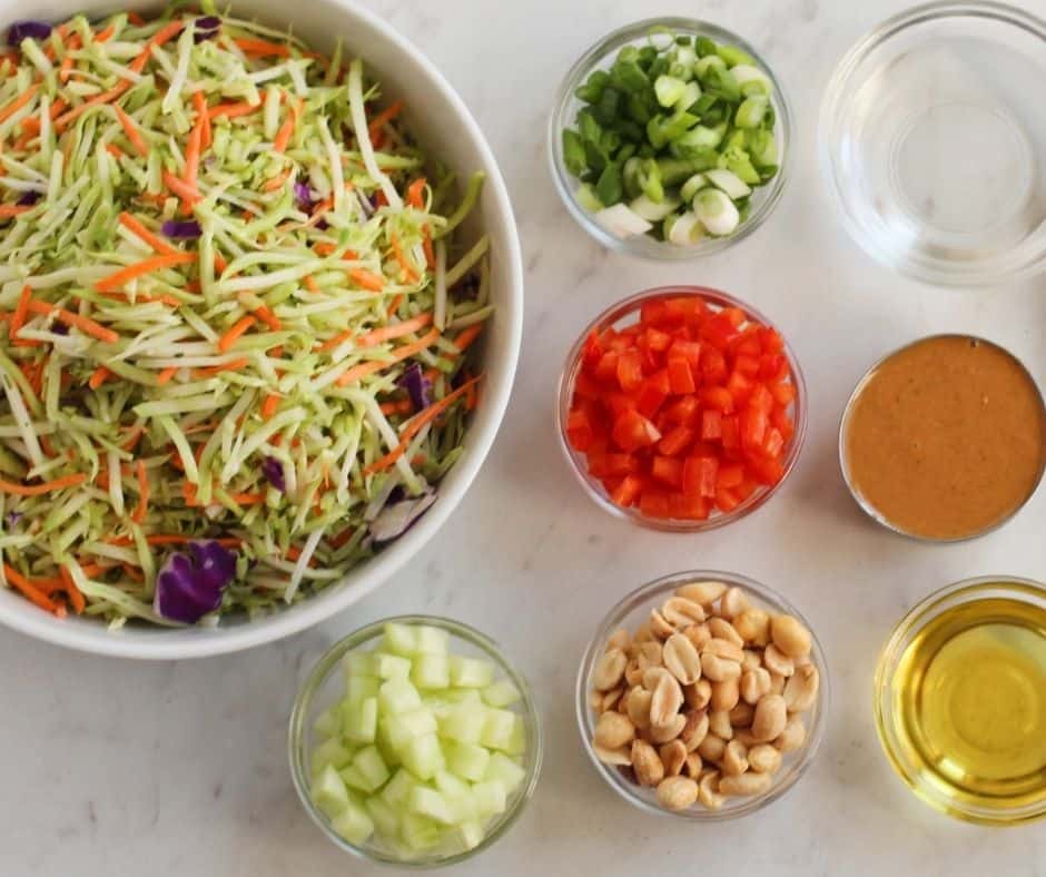 "Ingredients for Spicy Thai Salad with Chicken, including chopped greens, peanuts, and Thai dressing."