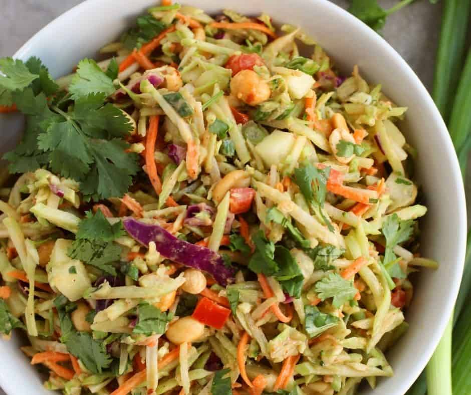 "Drizzling homemade peanut dressing over Spicy Thai Salad with Chicken."