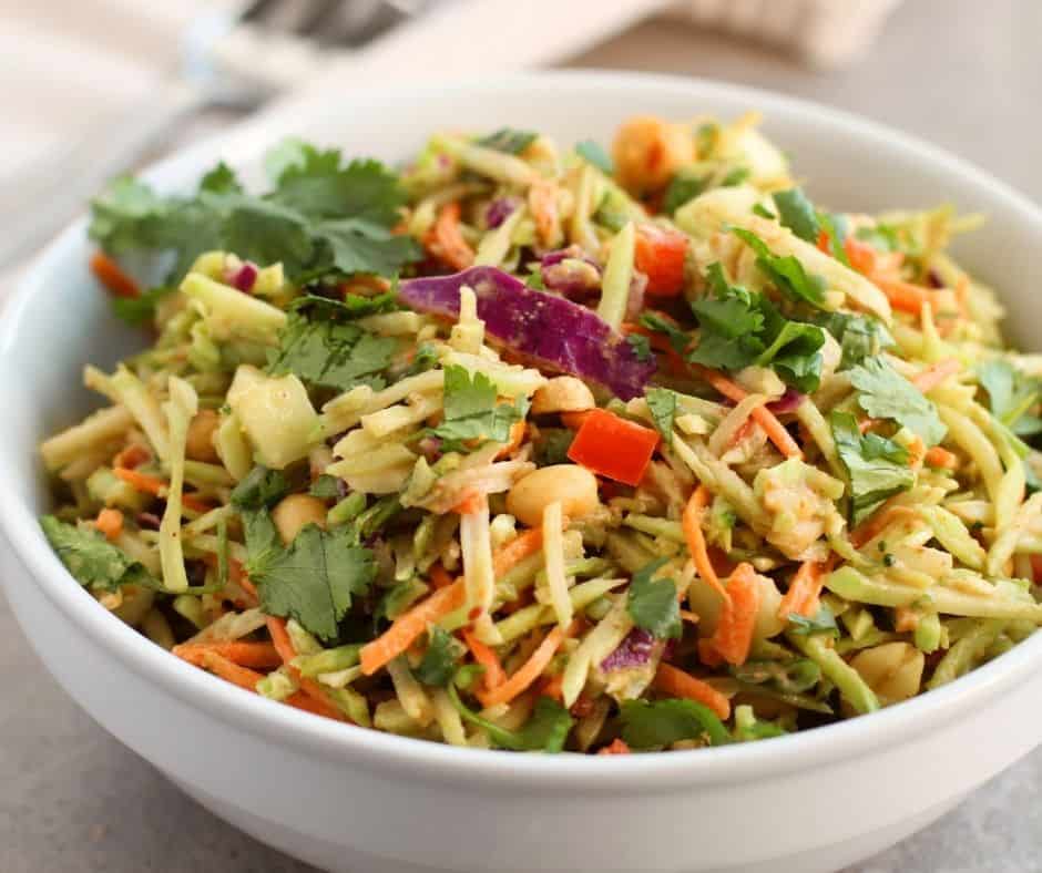 Close-up of Spicy Thai Salad with grilled chicken, fresh greens, and peanut dressing."