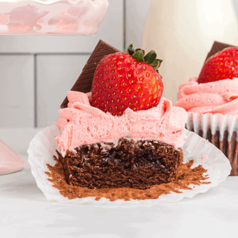 Air fryer Valentine cupcakes with pink and red frosting, decorated with sprinkles for Valentine’s Day.