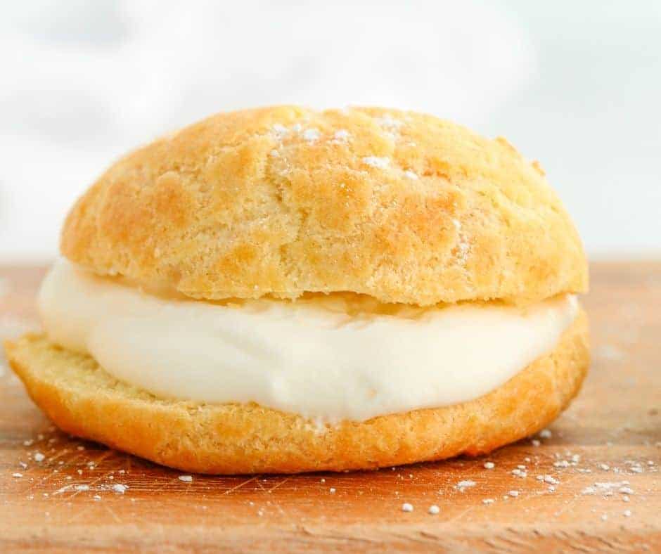 Golden and puffed air fryer cream puffs filled with homemade whipped cream.