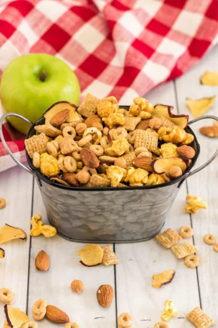 Cooled caramel apple trail mix with set caramel clusters on a sheet pan