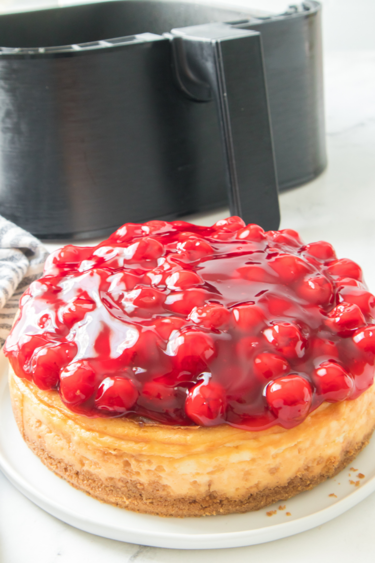 Homemade creamy cheesecake inspired by Cheesecake Factory served with whipped cream topping
