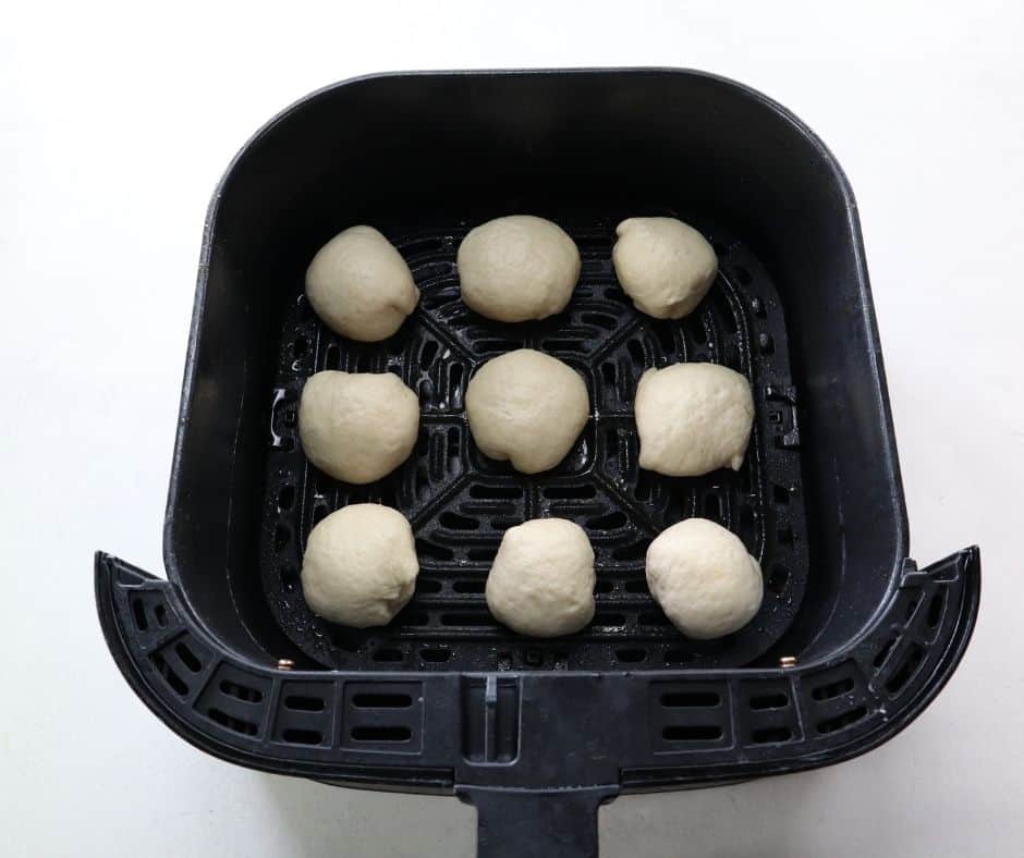 Stuffed Bagel Balls in Air Fryer: Bagel balls arranged in the air fryer basket, ready to be cooked.