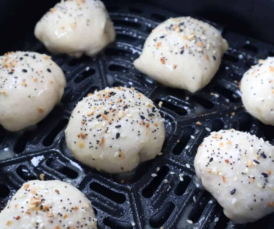 Air Frying Stuffed Bagel Balls: Bagel balls cooking in the air fryer, showing a golden and crispy exterior.