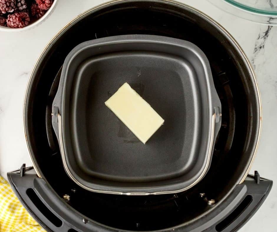 Melt butter in the air fryer pan, which will help you create the perfect crust.