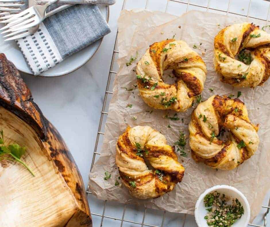 Close-up of the pumpkin twists showing the puff pastry's crisp layers and the savory filling peeking through.