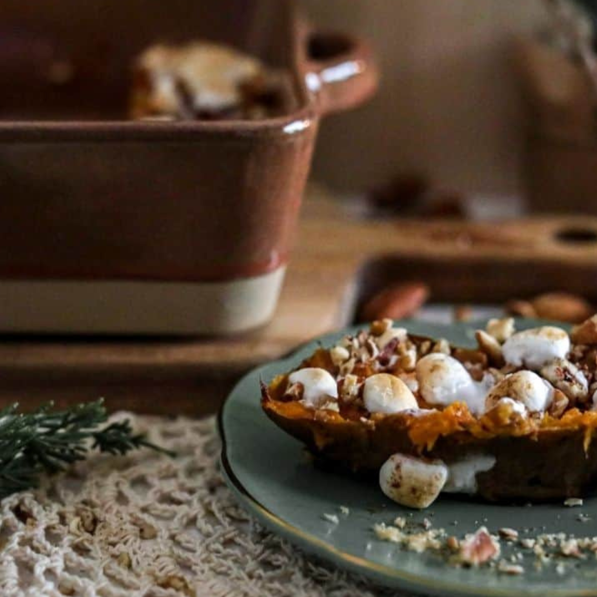 "A perfectly baked Texas Roadhouse Loaded Sweet Potato topped with honey cinnamon butter, melted marshmallows, and caramel sauce."