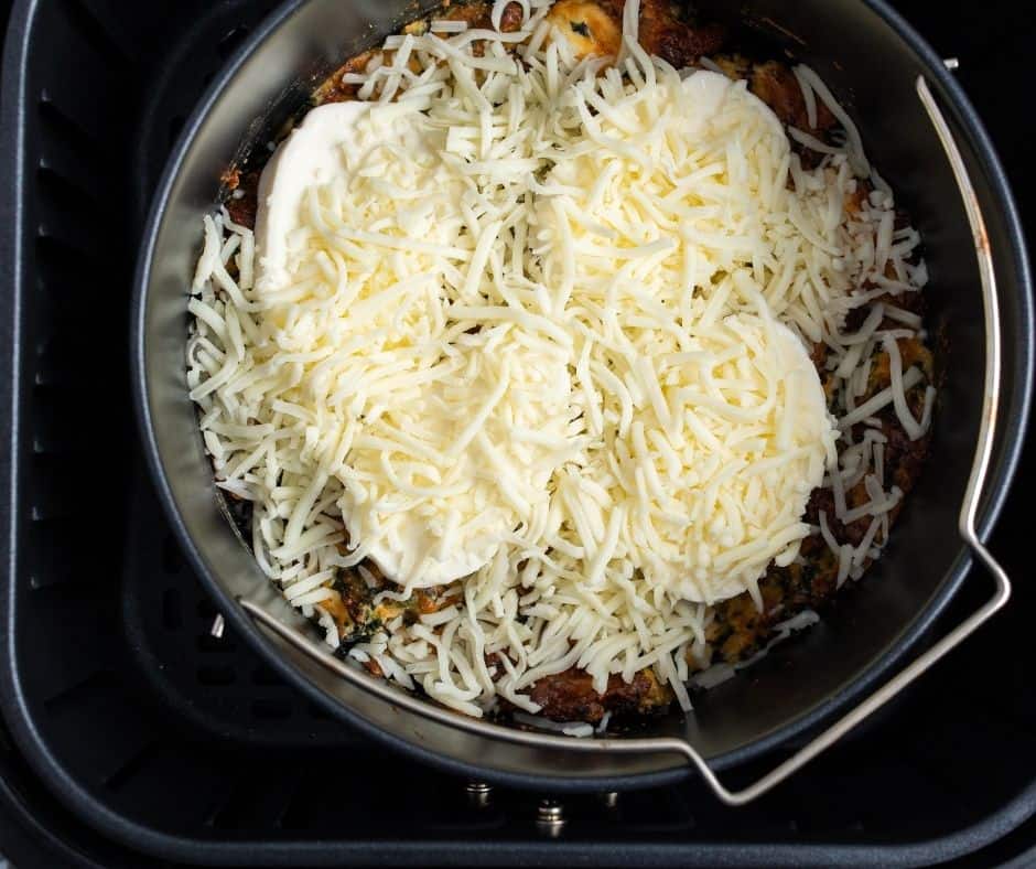 Image of Mozzarella Cheese Slices Layered on Top of the Dip: Adding the final touch of cheese for a delicious, melted crust.