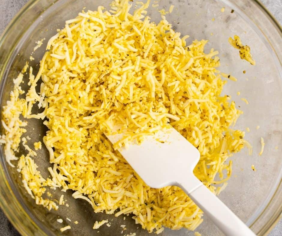 Mix egg, oregano, and garlic salt in a small bowl, then fold in shredded mozzarella cheese until well combined.