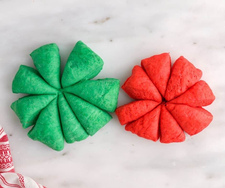 Adding red and green food coloring to portions of the dough for a festive appearance