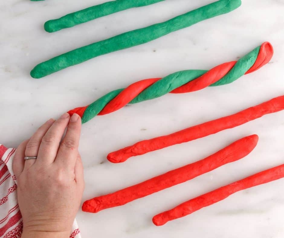 Shaping the colored dough into bagel rings, preparing them for the air fryer