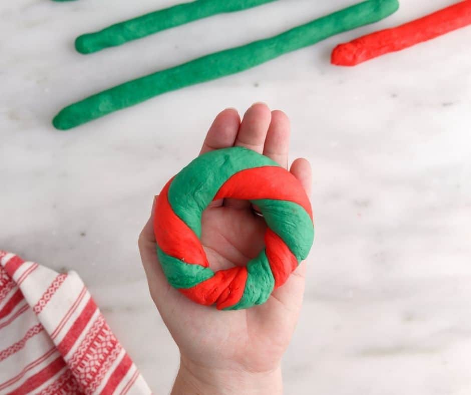 Twisting the red and green bagel dough to make Christmas Bagels