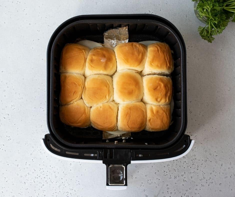 In a small bowl, mix melted butter and garlic powder, then brush the mixture on top of the rolls. Air fry at 310°F for 5 to 8 minutes until the cheese melts, and sprinkle with parsley before serving.