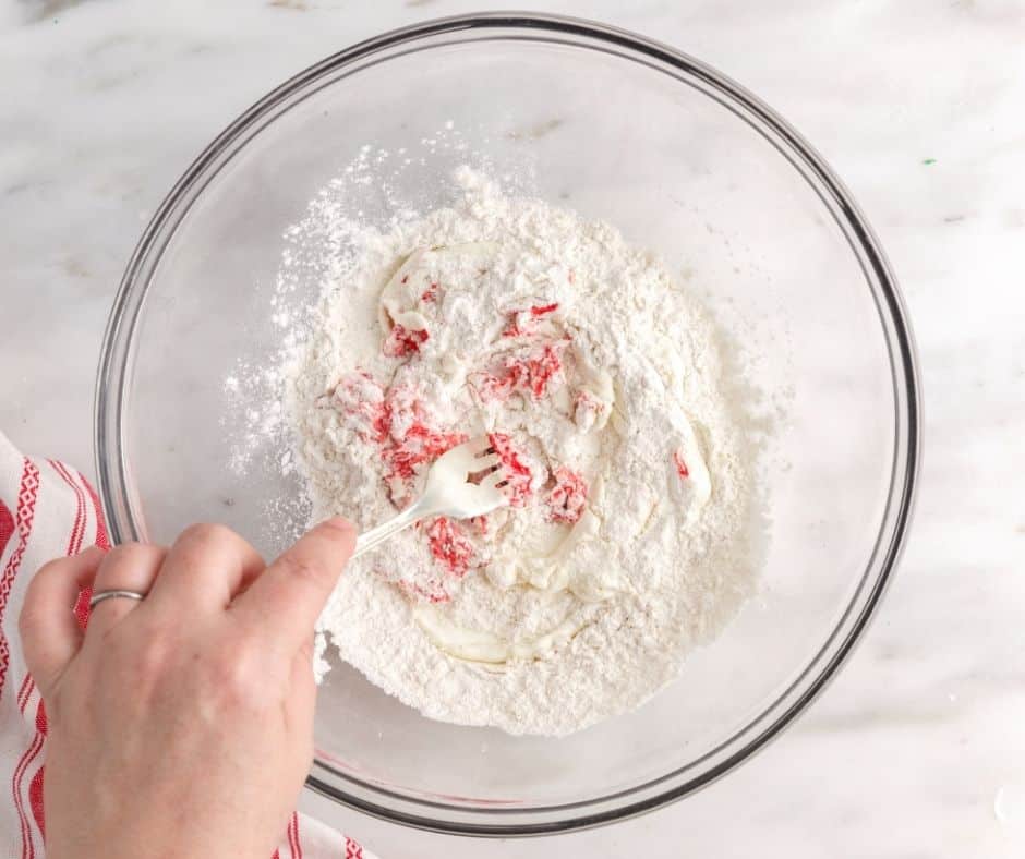 Mixing the bagel dough with self-rising flour and Greek yogurt to create a smooth, elastic consistency