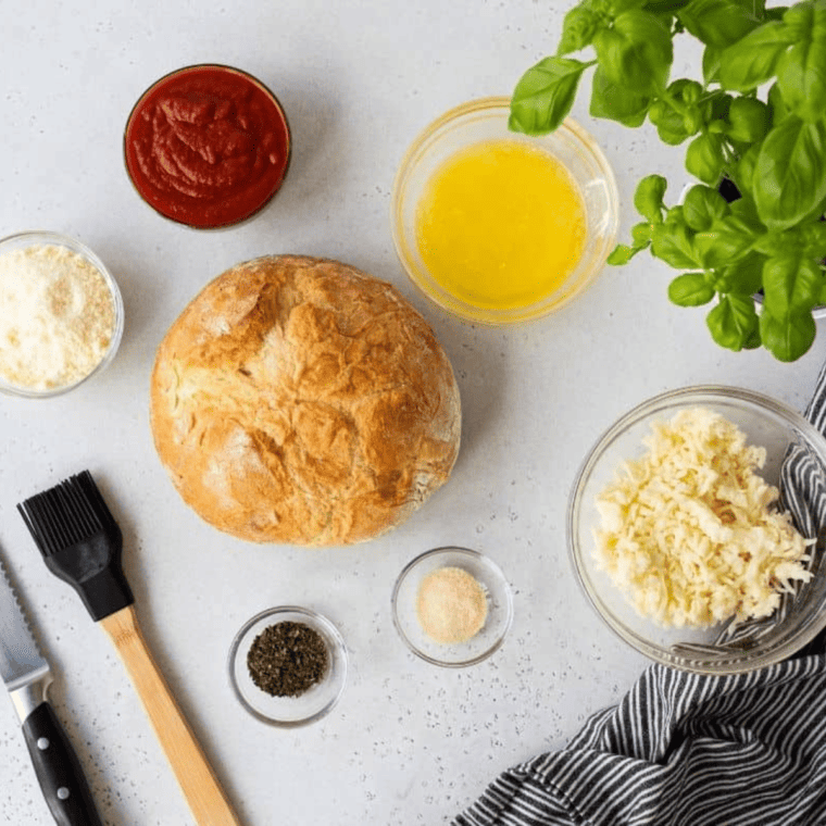 Ingredients needed for Air Fryer Mozzarella Pizza Bread on kitchen table.