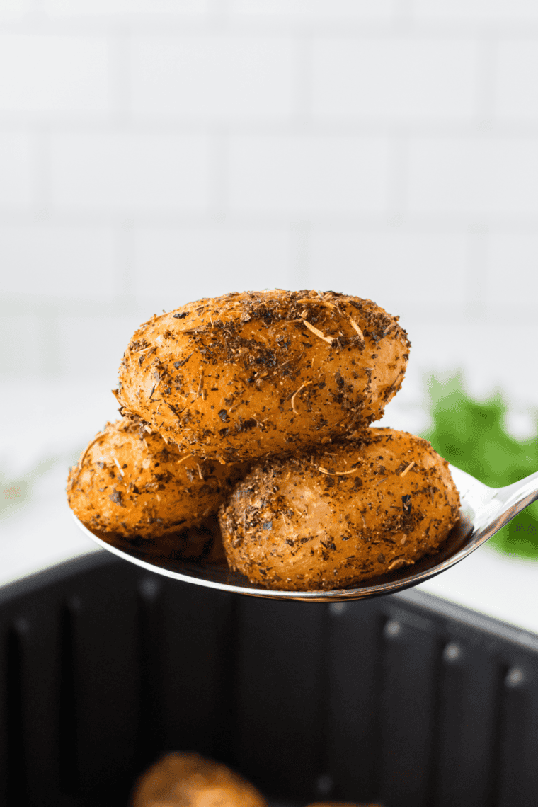 Golden brown air fryer canned potatoes seasoned to perfection and served in a bowl, crispy on the outside and tender on the inside.