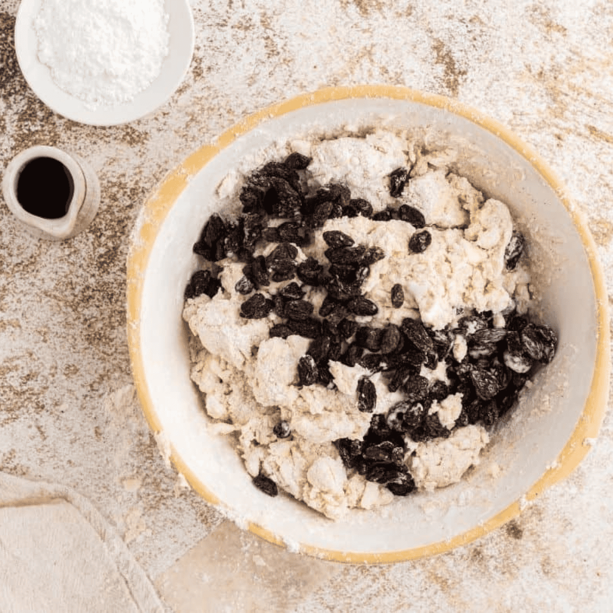 Using a pastry blender or two forks to cut cold butter into flour until pea-sized crumbs form.