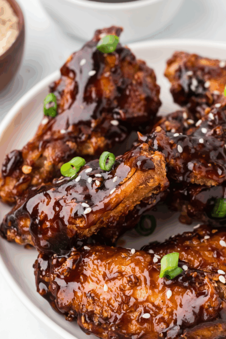 Golden-brown Benihana-style chicken wings served on a plate with dipping sauce.