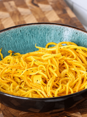 Bowl of air fryer butternut squash noodles with crispy golden edges
