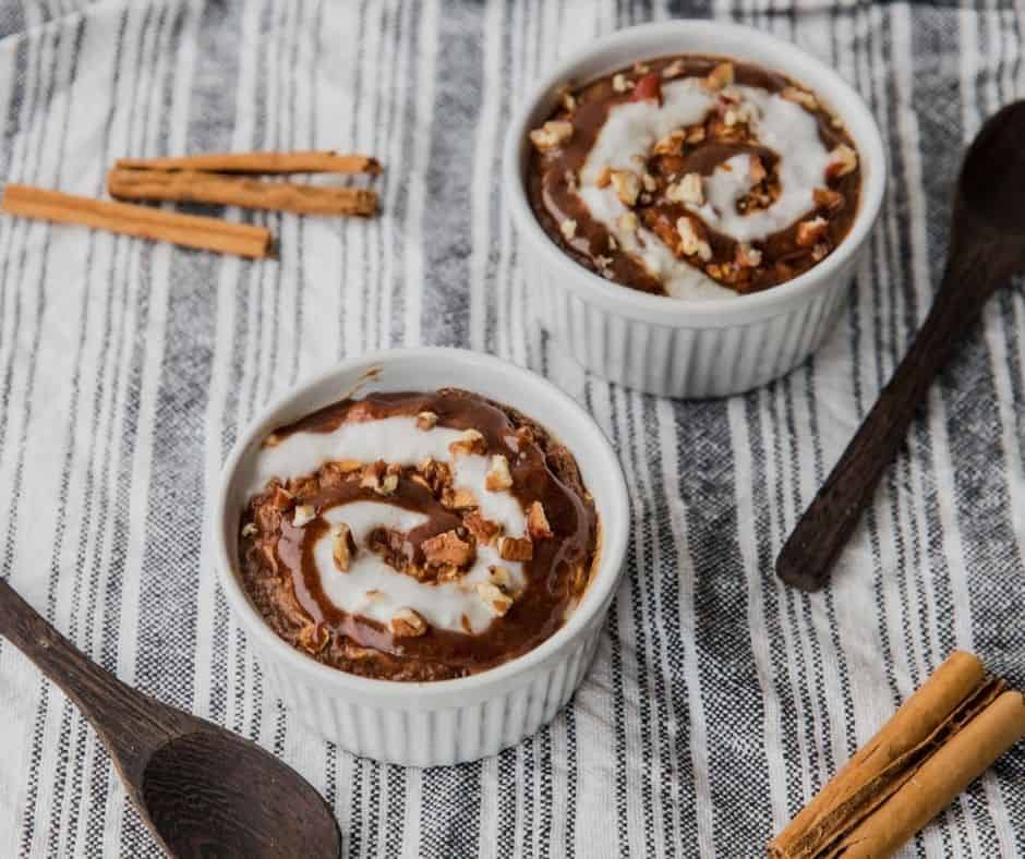 Air Fryer Cinnamon Roll Baked Oatmeal served warm in a bowl with a cinnamon swirl and chopped pecans