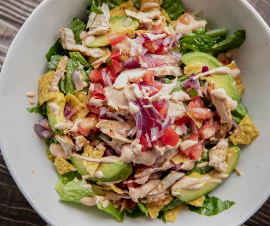Air Fryer Copycat Chili's Santa Fe Chicken Salad in a white bowl with grilled chicken and fresh vegetables