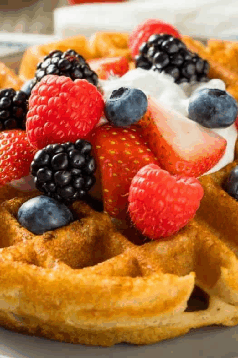 Air fryer Kodiak cake waffles cooked to golden perfection, served with syrup and fresh fruit.