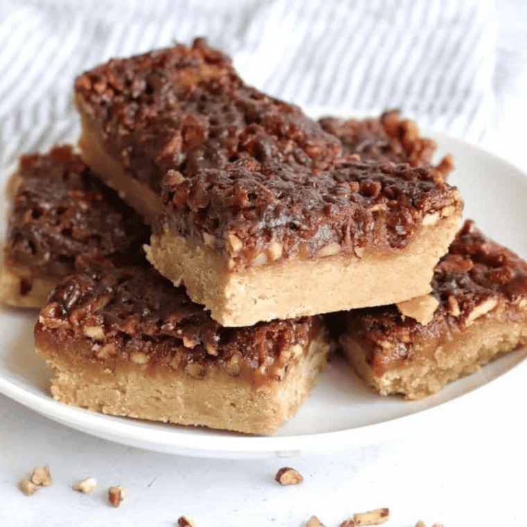 A plate of golden, crispy Air Fryer Maple Pecan Bars topped with a rich maple and pecan filling.