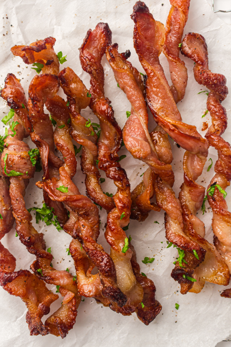 Air fryer bacon strips twisted into spirals and cooked until crunchy and caramelized for a viral TikTok method that makes bacon better