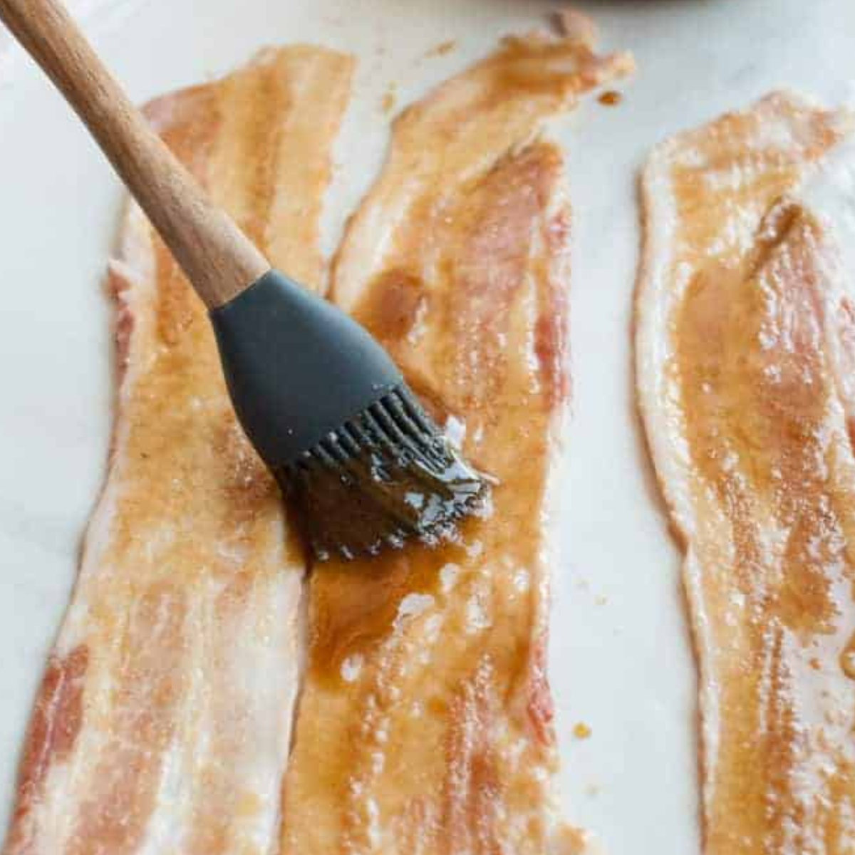 Step-by-step process of making Air Fryer Twisted Candied Bacon, featuring raw bacon coated with brown sugar and spices, ready to be twisted and air-fried for a sweet and crispy treat.