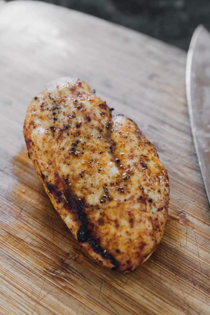 Sliced air-fried chicken breast on a cutting board for Santa Fe Chicken Salad