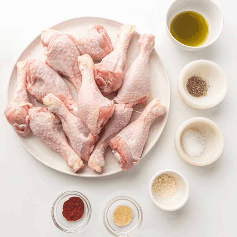 Ingredients needed for Easy Air Fryer Garlic Parmesan Chicken Legs on kitchen table.