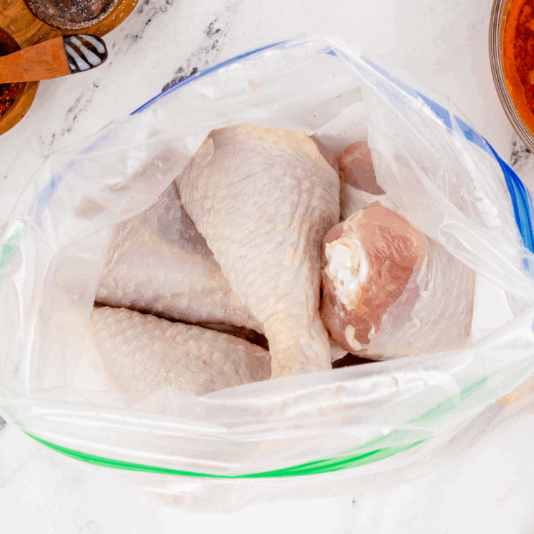 Coating the chicken drumsticks with the seasoning mix.
