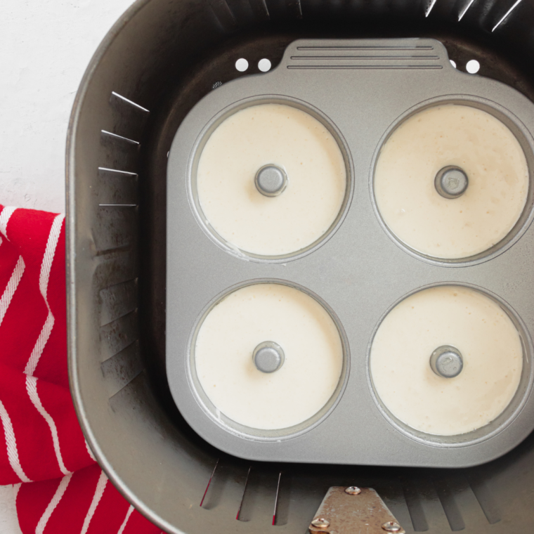 Batter piped neatly into donut mold cavities
