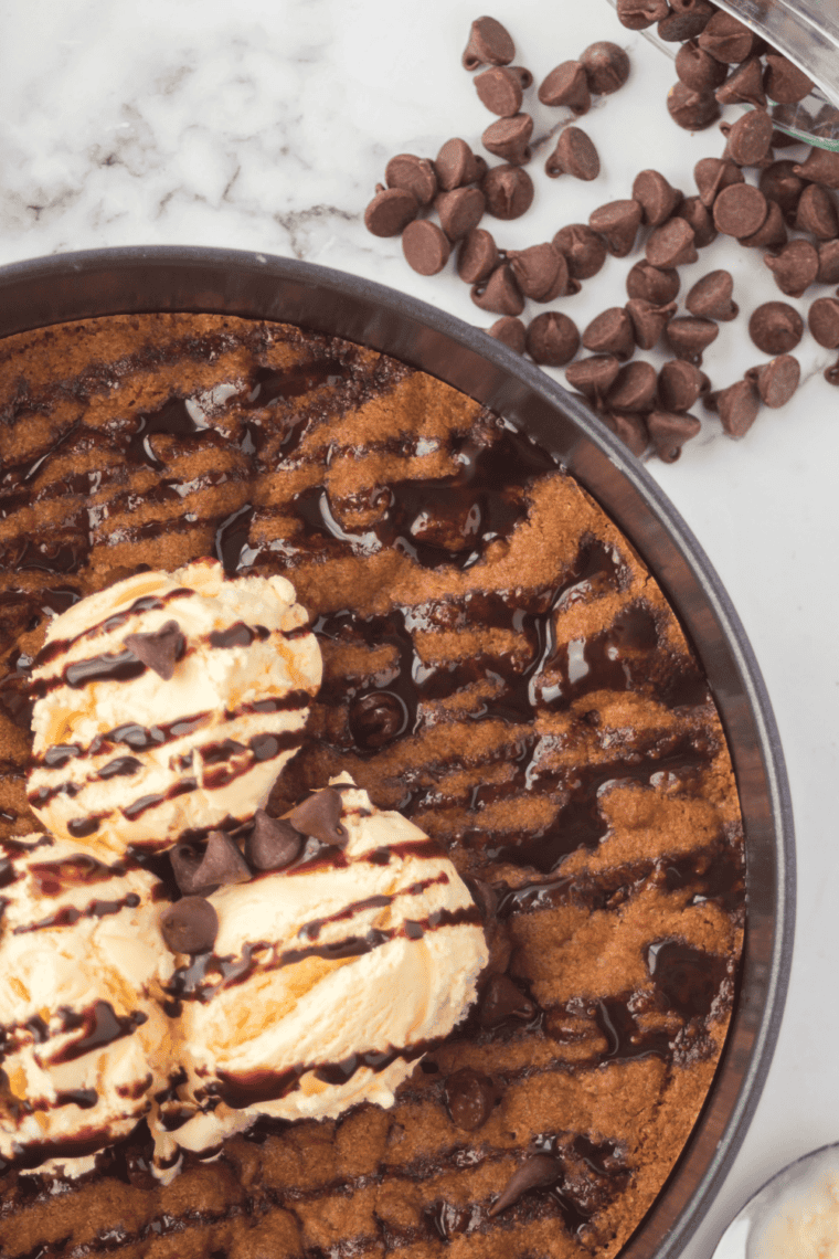 Air fryer chocolate chip pizookie with golden edges and gooey, melty chocolate center.