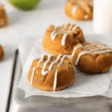 Slice of Easy Amish Apple Cake topped with powdered sugar on a rustic plate, showing moist apple chunks and golden cinnamon crumb.