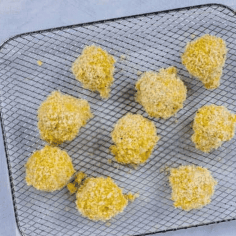 Preheat air fryer to 375°F, cook mushrooms in batches until crispy.