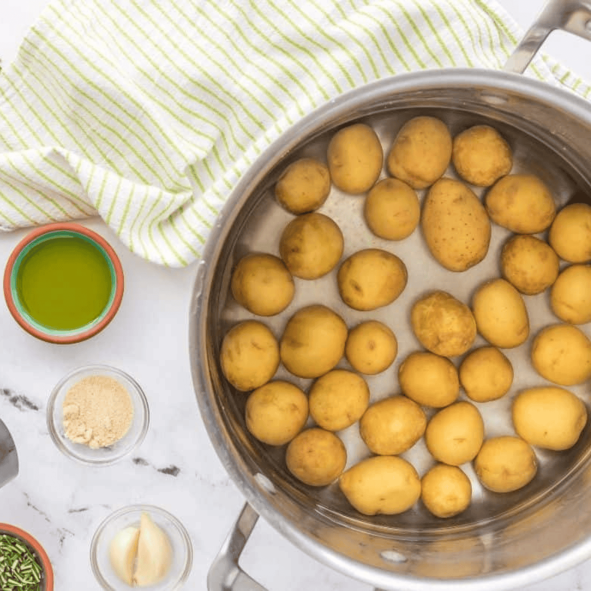 Baby potatoes washed and ready for boiling in a pot.