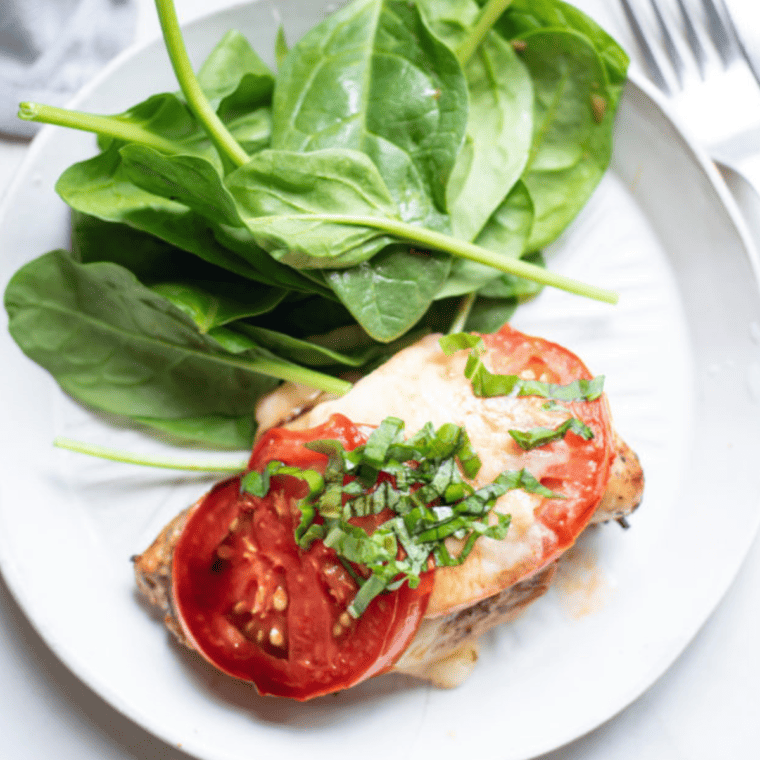 Finished caprese chicken drizzled with balsamic glaze