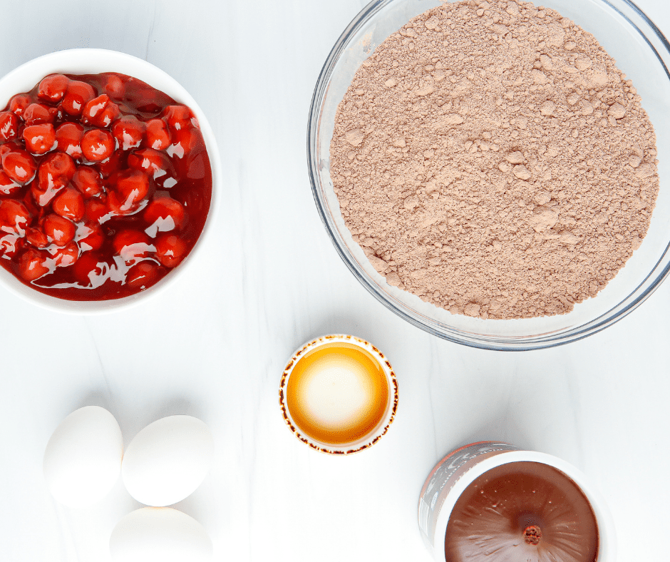 Ingredients for air fryer chocolate cherry cupcakes: devil's food cake mix, cherry pie filling, eggs, vanilla, and chocolate frosting