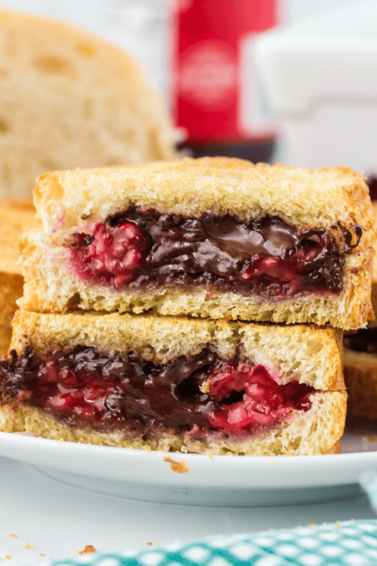 Air fryer sandwich with melted mascarpone, fresh raspberries, and chocolate chips golden brown and crispy